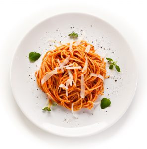 Pasta with meat and vegetables on white background